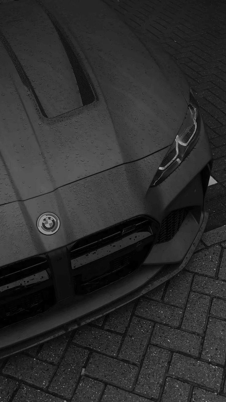 Water beading across the coated hood of a BMW M4