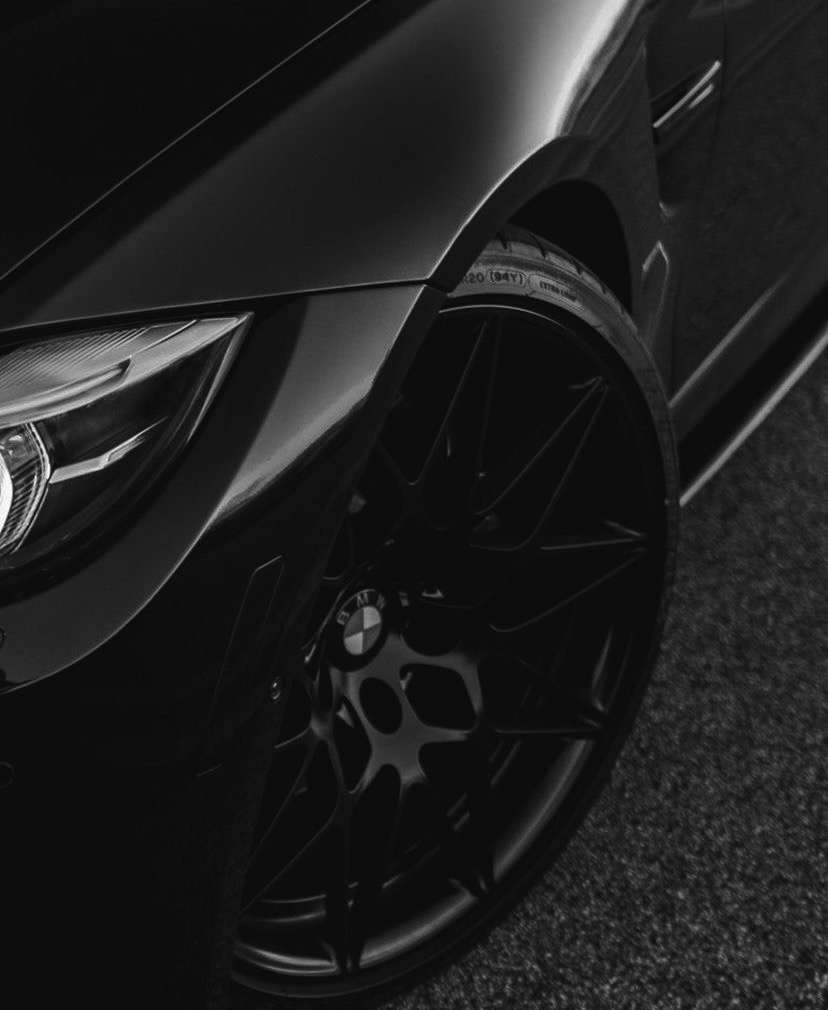 Deep-cleaned black BMW wheel and dressed tire, spotless behind the spokes